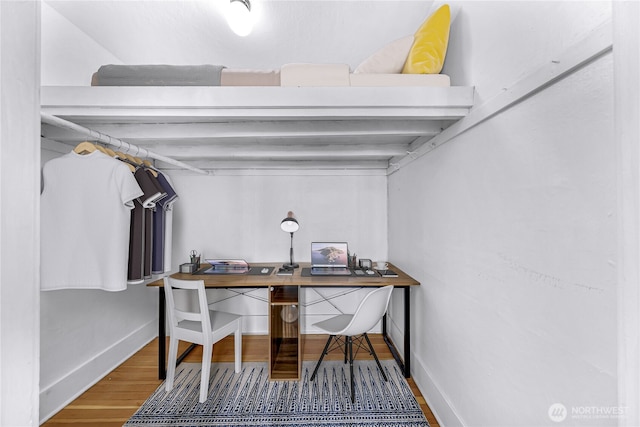 4725 15th Ave NE Unit 37, Seattle, WA 98105 - below grade area featuring wood finished floors, a desk, and baseboards
