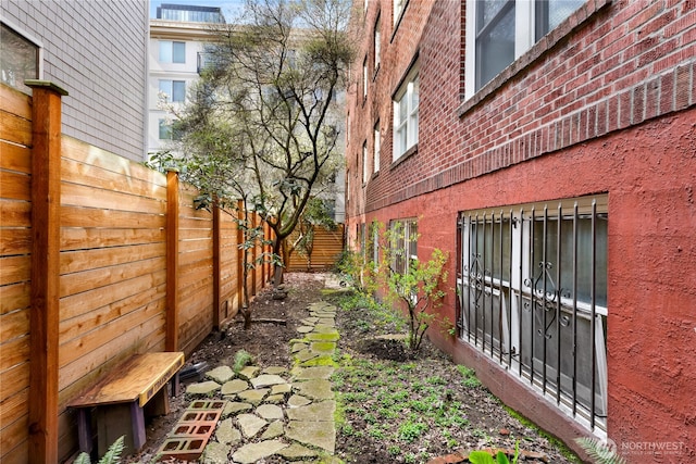 4725 15th Ave NE Unit 37, Seattle, WA 98105 - view of side of property featuring a fenced backyard and brick siding