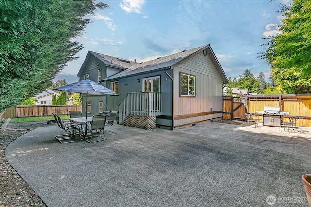 32116 Sunny Ln, Black Diamond, WA 98010 - rear view of house featuring a patio, crawl space, a gate, a shingled roof, and outdoor dining area