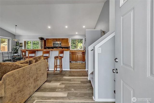 32116 Sunny Ln, Black Diamond, WA 98010 - living room featuring vaulted ceiling, wood finished floors, and recessed lighting