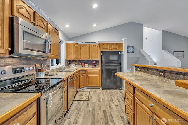 32116 Sunny Ln, Black Diamond, WA 98010 - kitchen featuring stainless steel appliances, a sink, light wood-style flooring, tile countertops, and lofted ceiling
