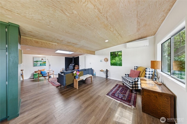 18482 Pull And Be Damned Rd, La Conner, WA 98257 - living room featuring an AC wall unit, a wood stove, wood finished floors, plenty of natural light, and wooden ceiling