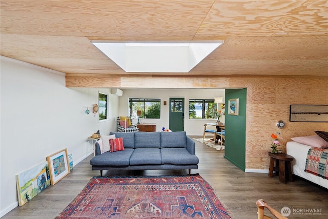 18482 Pull And Be Damned Rd, La Conner, WA 98257 - living area featuring a skylight, baseboards, and wood finished floors
