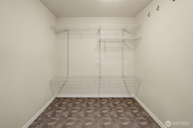 5011 5th Ave NE, Seattle, WA 98105 - walk in closet featuring dark colored carpet