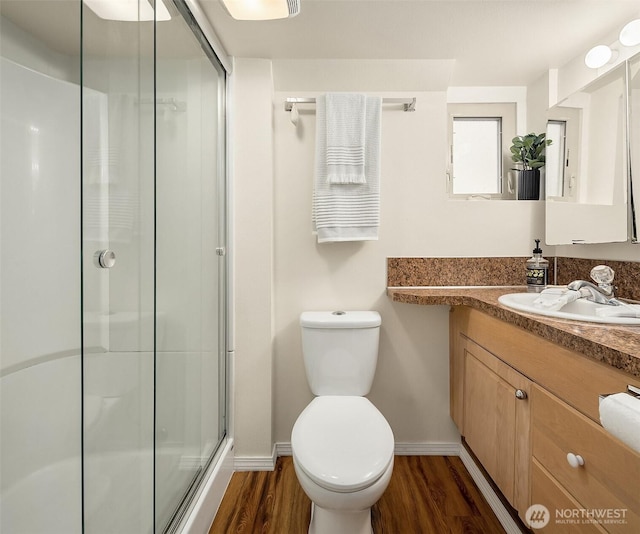 5011 5th Ave NE, Seattle, WA 98105 - full bathroom featuring baseboards, wood finished floors, vanity, and an enclosed shower