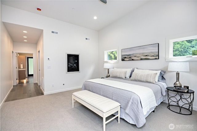 6050 Chorus Frog St NE, Bainbridge Island, WA 98110 - bedroom with carpet flooring, multiple windows, baseboards, recessed lighting, and a towering ceiling
