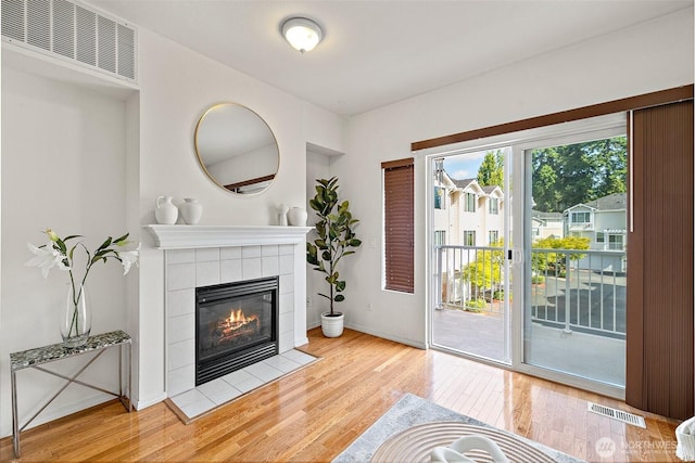11864 NE 162nd Ln Unit 11-2, Bothell, WA 98011 - living room with light wood-style floors, a tiled fireplace, and baseboards