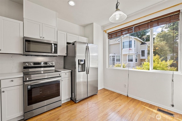 11864 NE 162nd Ln Unit 11-2, Bothell, WA 98011 - kitchen featuring stainless steel appliances, light countertops, recessed lighting, baseboards, and white cabinets