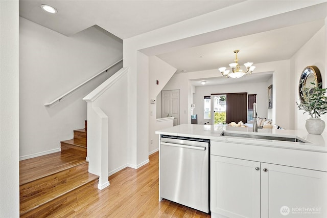 11864 NE 162nd Ln Unit 11-2, Bothell, WA 98011 - kitchen with stainless steel dishwasher, a sink, a chandelier, light wood-style flooring, and light countertops