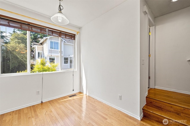 11864 NE 162nd Ln Unit 11-2, Bothell, WA 98011 - empty room featuring light wood finished floors, plenty of natural light, and baseboards