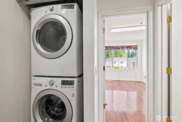 11864 NE 162nd Ln Unit 11-2, Bothell, WA 98011 - washroom with stacked washer and clothes dryer and wood finished floors