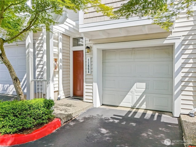 11864 NE 162nd Ln Unit 11-2, Bothell, WA 98011 - doorway to property with a garage and asphalt driveway