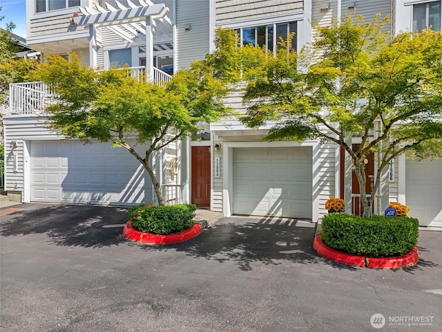 11864 NE 162nd Ln Unit 11-2, Bothell, WA 98011 - view of front facade with asphalt driveway, an attached garage, and a balcony