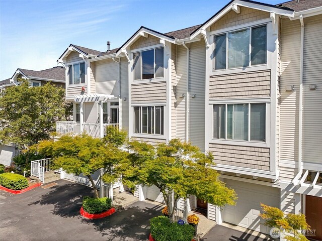 11864 NE 162nd Ln Unit 11-2, Bothell, WA 98011 - view of front of house featuring a garage, roof with shingles, and asphalt driveway