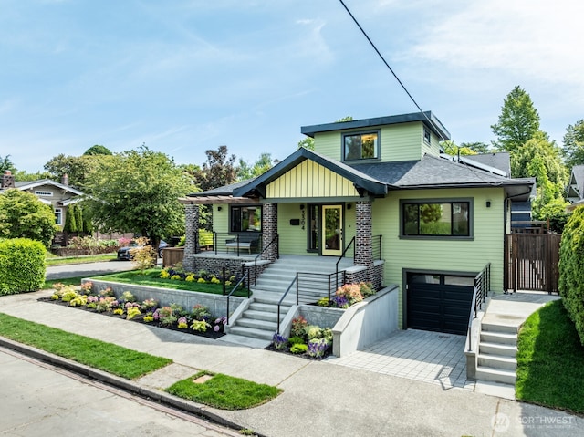 3304 37th Ave S, Seattle, WA 98144 - view of front of house with a garage, stairway, covered porch, driveway, and roof with shingles