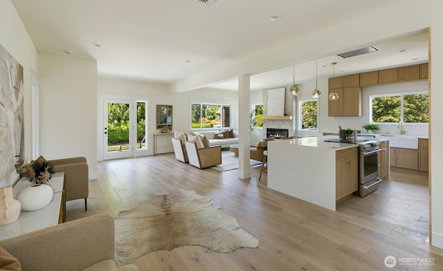 3304 37th Ave S, Seattle, WA 98144 - kitchen with open floor plan, stainless steel range with electric stovetop, a fireplace, and recessed lighting