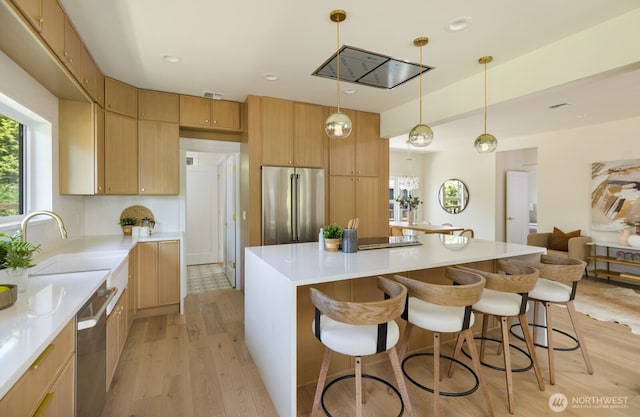 3304 37th Ave S, Seattle, WA 98144 - kitchen featuring stainless steel appliances, light wood finished floors, a breakfast bar, a center island, and recessed lighting