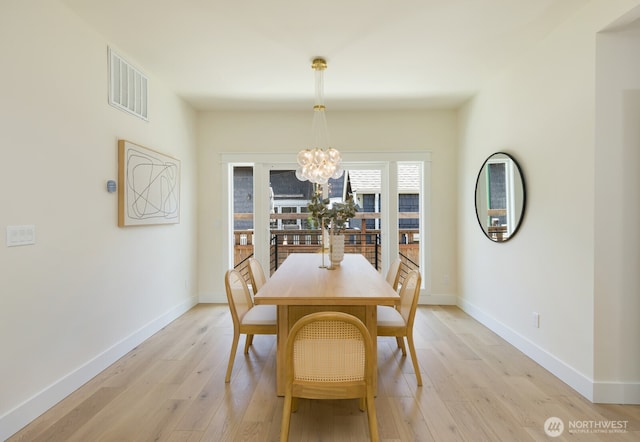 3304 37th Ave S, Seattle, WA 98144 - dining room with a chandelier, light wood-style floors, and baseboards