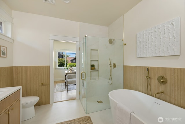 3304 37th Ave S, Seattle, WA 98144 - bathroom featuring a wainscoted wall, vanity, a shower stall, a freestanding bath, and toilet