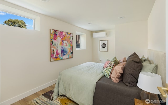 3304 37th Ave S, Seattle, WA 98144 - bedroom featuring a wall unit AC, light wood-type flooring, and baseboards