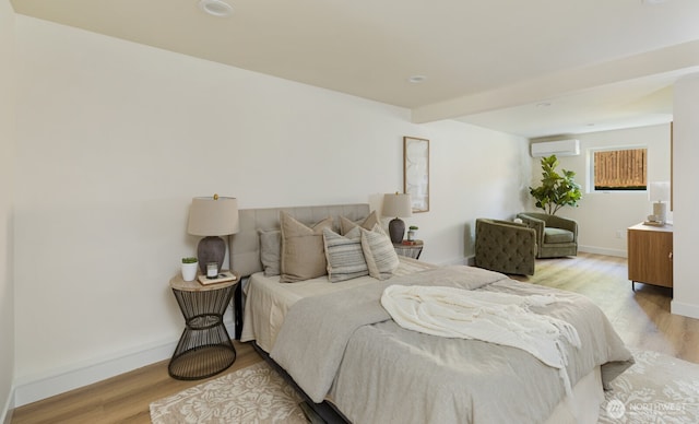 3304 37th Ave S, Seattle, WA 98144 - bedroom featuring a wall mounted AC, light wood-style flooring, and baseboards
