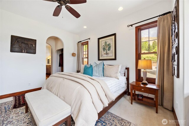 134 Borealis Ln, Manson, WA 98831 - bedroom featuring arched walkways, light carpet, baseboards, recessed lighting, and a ceiling fan