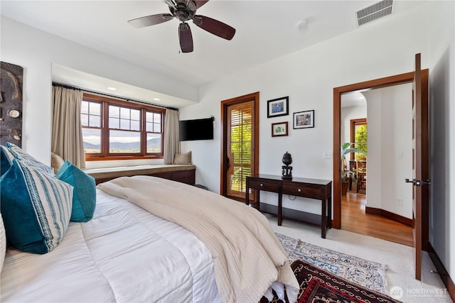 134 Borealis Ln, Manson, WA 98831 - carpeted bedroom featuring multiple windows, baseboards, and ceiling fan
