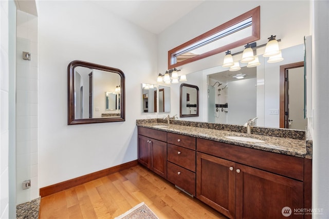 134 Borealis Ln, Manson, WA 98831 - full bathroom featuring wood finished floors, double vanity, baseboards, and a shower