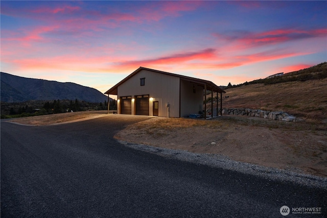 134 Borealis Ln, Manson, WA 98831 - outdoor structure at dusk featuring a mountain view and driveway