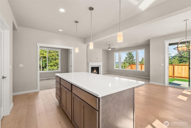 9645 7th Ave SE, Lacey, WA 98513 - kitchen with light wood-type flooring, a center island, healthy amount of natural light, open floor plan, and recessed lighting