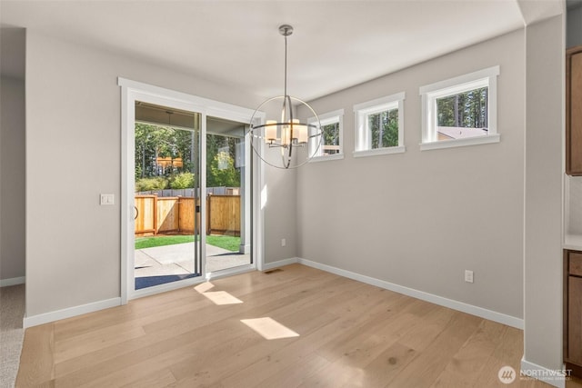 9645 7th Ave SE, Lacey, WA 98513 - unfurnished dining area featuring a chandelier and light wood-style flooring
