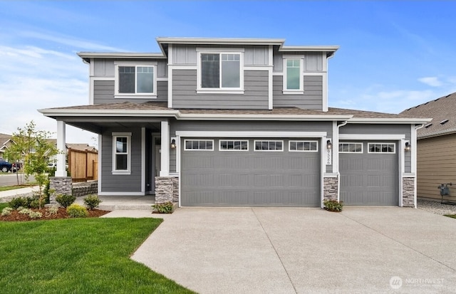 9645 7th Ave SE, Lacey, WA 98513 - prairie-style house featuring board and batten siding, stone siding, driveway, a front yard, and an attached garage