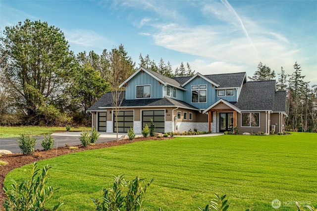 3848 Marine Way, Bellingham, WA 98225 - view of front of property featuring driveway, board and batten siding, a garage, a front yard, and stone siding