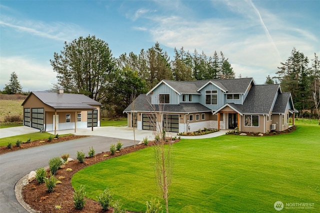 3848 Marine Way, Bellingham, WA 98225 - view of front of house featuring driveway, a front lawn, board and batten siding, and a garage