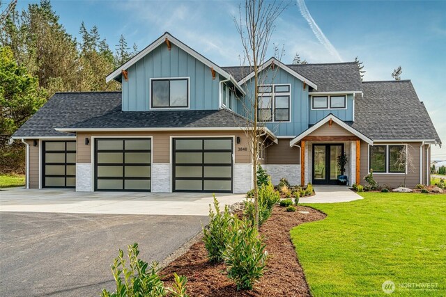 3848 Marine Way, Bellingham, WA 98225 - view of front of property with french doors, board and batten siding, a front lawn, asphalt driveway, and stone siding