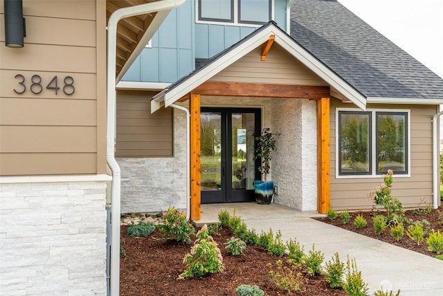 3848 Marine Way, Bellingham, WA 98225 - view of exterior entry with french doors, board and batten siding, a shingled roof, and brick siding