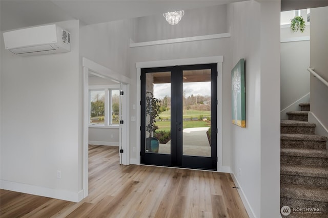3848 Marine Way, Bellingham, WA 98225 - entrance foyer featuring a wall mounted air conditioner, french doors, wood finished floors, stairs, and baseboards