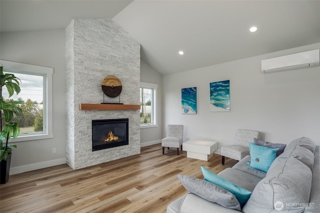 3848 Marine Way, Bellingham, WA 98225 - living area featuring a wall mounted AC, a fireplace, baseboards, wood finished floors, and recessed lighting