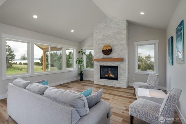 3848 Marine Way, Bellingham, WA 98225 - living room featuring vaulted ceiling, a fireplace, wood finished floors, baseboards, and recessed lighting