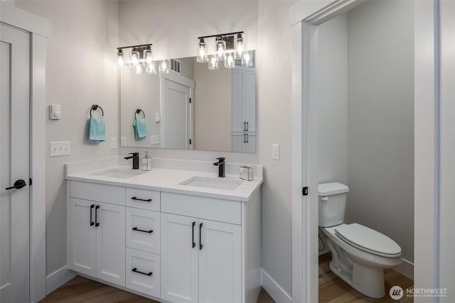 3848 Marine Way, Bellingham, WA 98225 - full bathroom featuring double vanity, baseboards, toilet, and wood finished floors