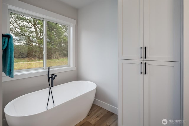 3848 Marine Way, Bellingham, WA 98225 - bathroom with healthy amount of natural light, a freestanding bath, baseboards, and wood finished floors