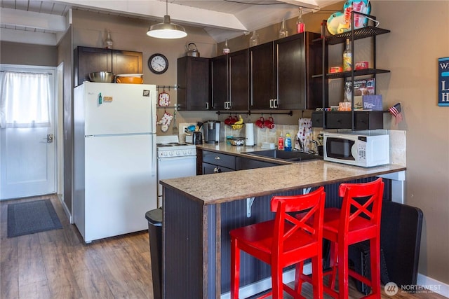 135 Furey Ave, Manson, WA 98831 - kitchen featuring white appliances, open shelves, a sink, light wood finished floors, and dark brown cabinetry