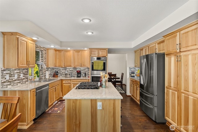 1228 Tabitha Ct NW, Olympia, WA 98502 - kitchen with appliances with stainless steel finishes, a sink, a center island, light brown cabinetry, and dark wood-style floors