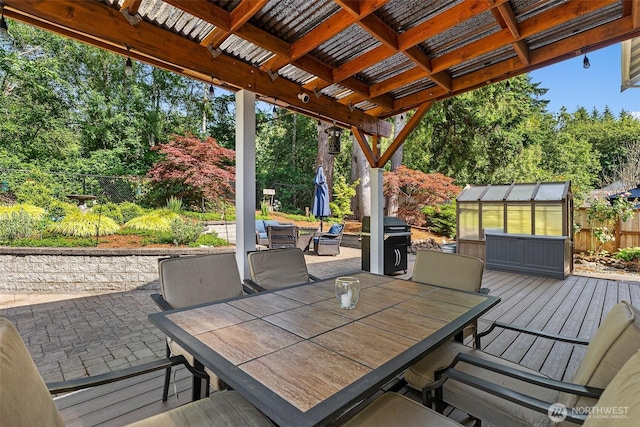 1228 Tabitha Ct NW, Olympia, WA 98502 - wooden terrace featuring outdoor dining space, an exterior structure, and a patio