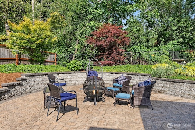 1228 Tabitha Ct NW, Olympia, WA 98502 - fenced backyard featuring a fire pit and a patio