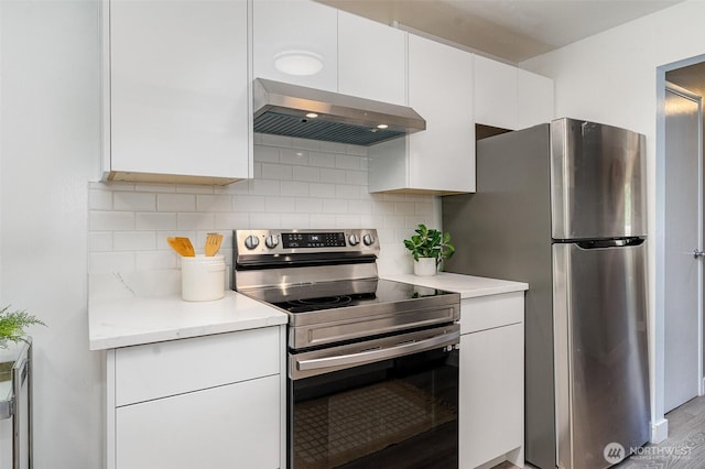 17109 NE 45th St Unit 36, Redmond, WA 98052 - kitchen featuring stainless steel appliances, wall chimney range hood, white cabinetry, and light countertops
