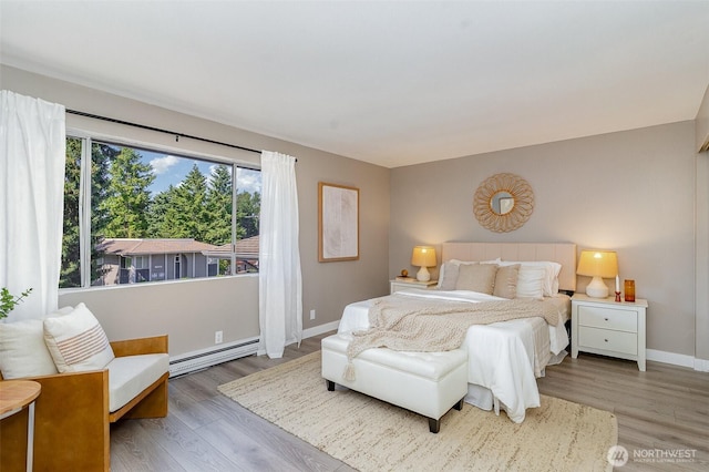 17109 NE 45th St Unit 36, Redmond, WA 98052 - bedroom featuring a baseboard radiator and wood finished floors
