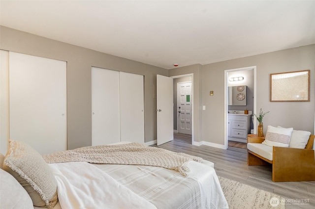 17109 NE 45th St Unit 36, Redmond, WA 98052 - bedroom with light wood-style floors, two closets, and ensuite bathroom
