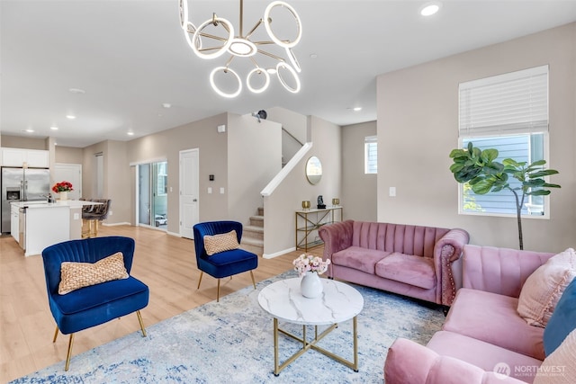 15834 205th Ave E, Bonney Lake, WA 98391 - living room featuring stairs, light wood-style flooring, recessed lighting, a chandelier, and baseboards