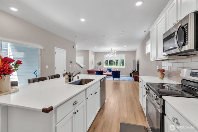 15834 205th Ave E, Bonney Lake, WA 98391 - kitchen featuring stainless steel appliances, a sink, light countertops, and recessed lighting